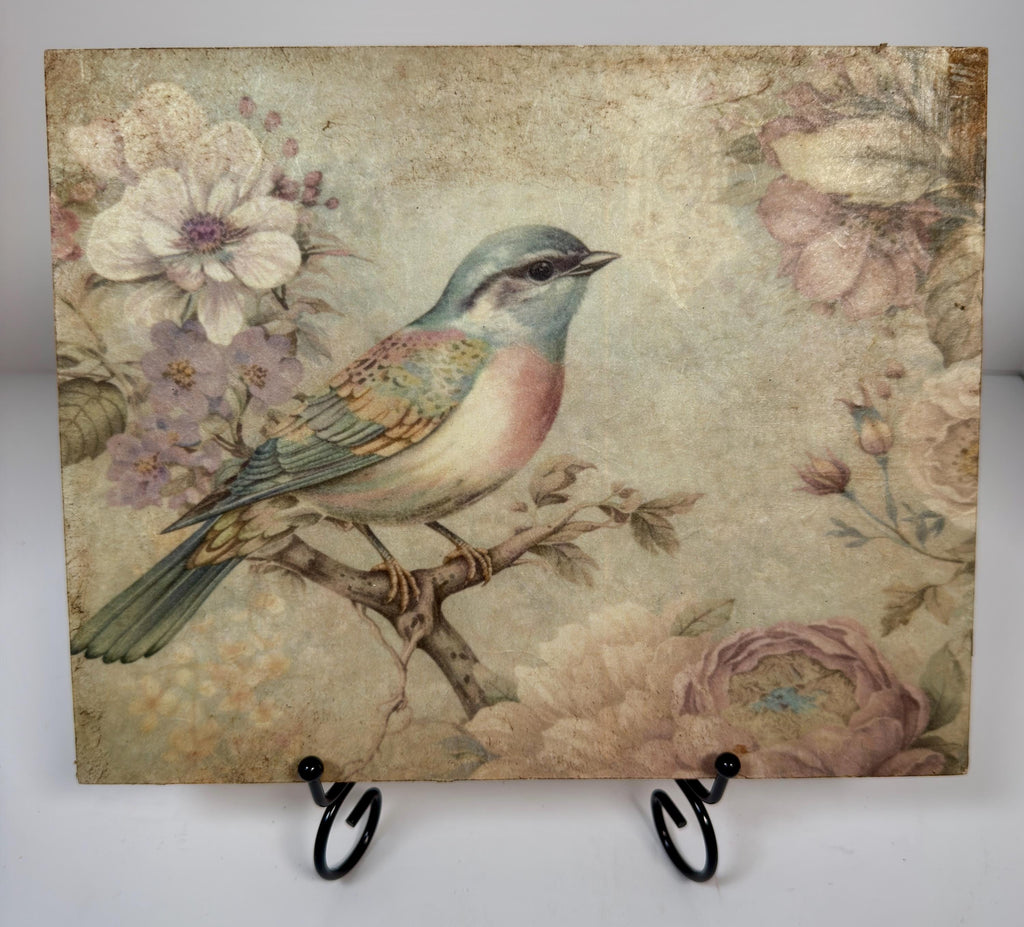 a vintage-style painting of a colorful bird perched on a branch, surrounded by flowers and foliage.