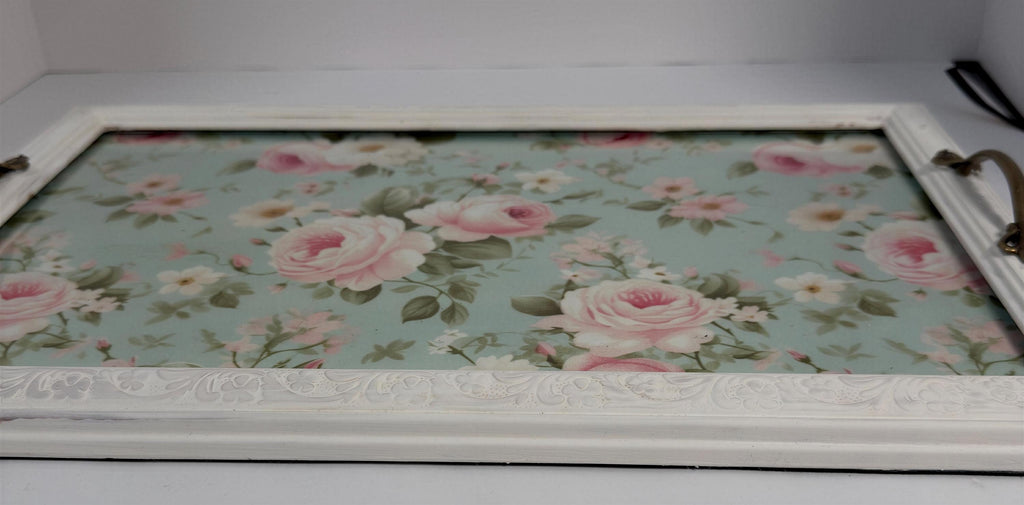 A white wooden tray with a floral pattern on the surface.