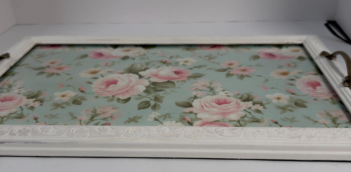 A white wooden tray with a floral pattern on the surface.