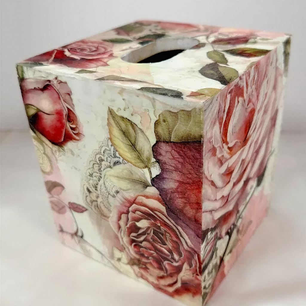 a square-shaped box with a floral pattern on it, including roses and leaves.
