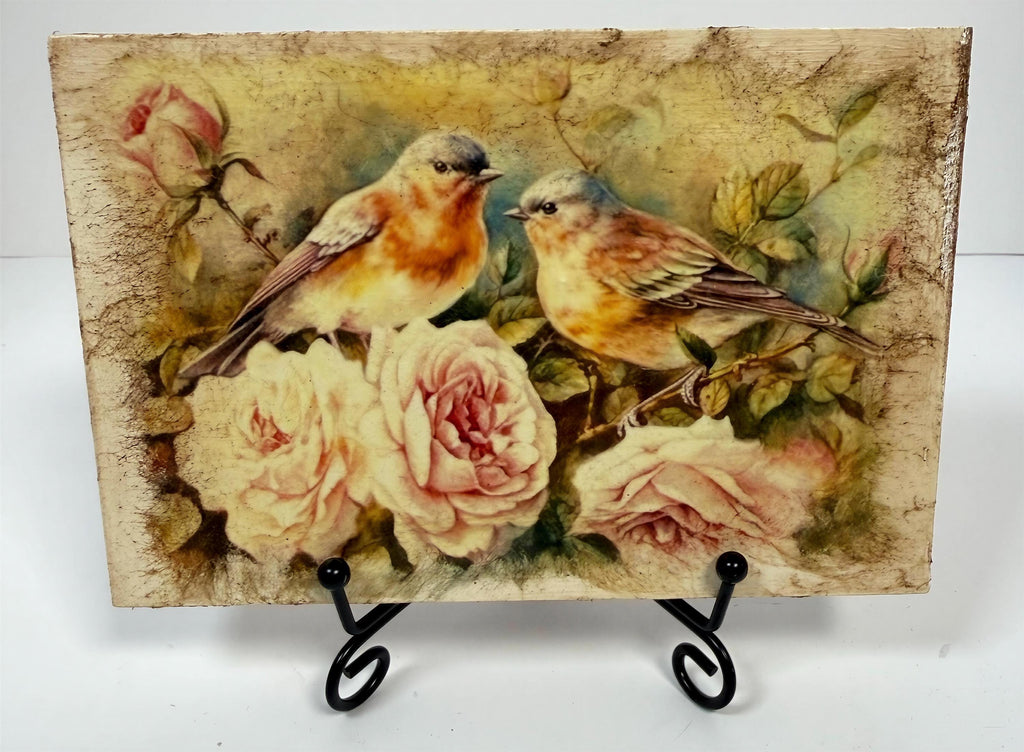 a painting of two birds perched on branches with pink roses in the background.
