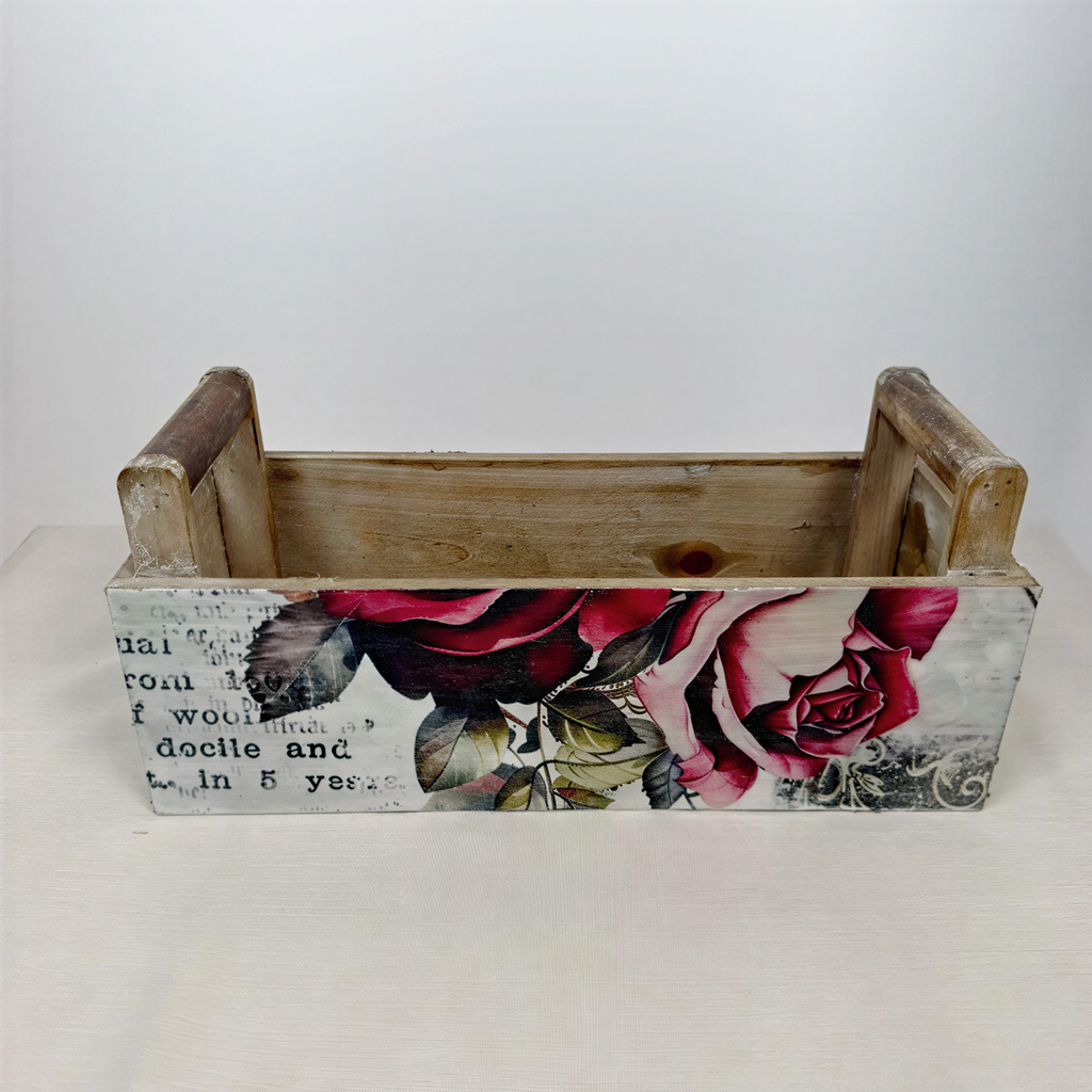 a wooden crate with a floral design on it.