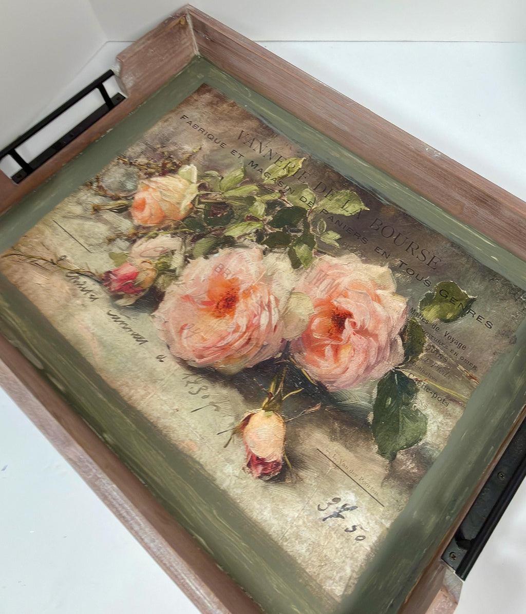 a wooden tray with a decorative floral print on it.