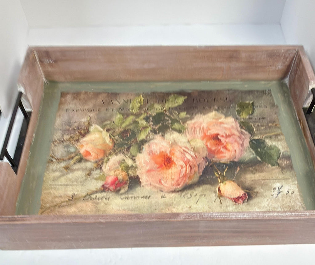 a wooden tray with a painting of pink roses on it.