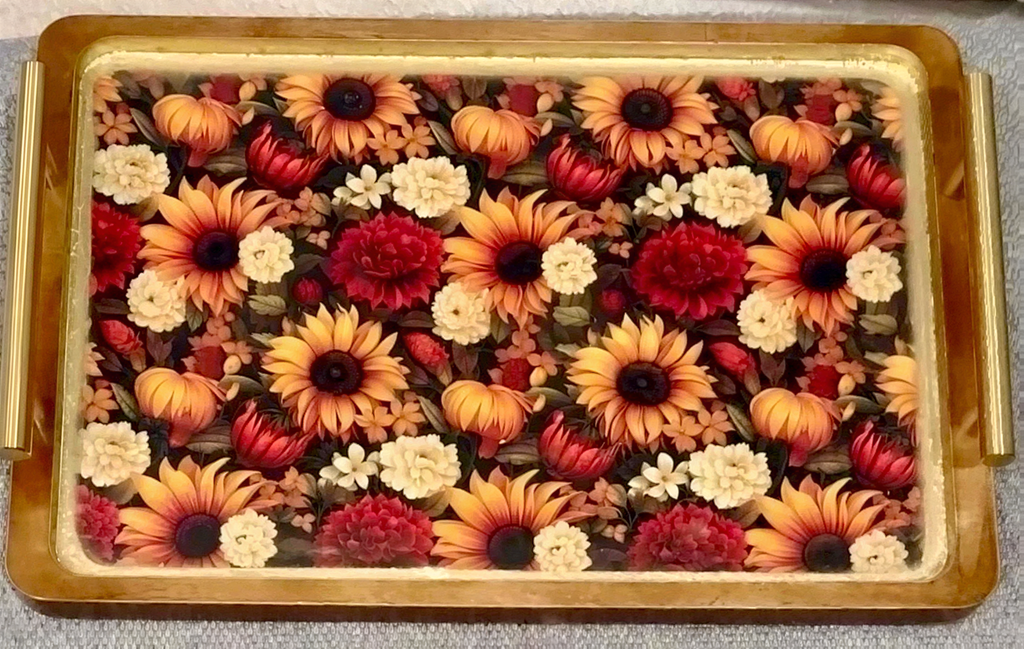 a wooden tray with a vibrant floral pattern of sunflowers and other flowers.