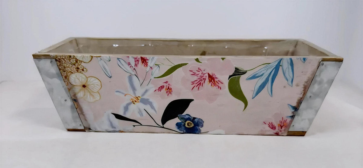 A rectangular planter with a floral pattern on its side, featuring various colorful flowers and leaves.