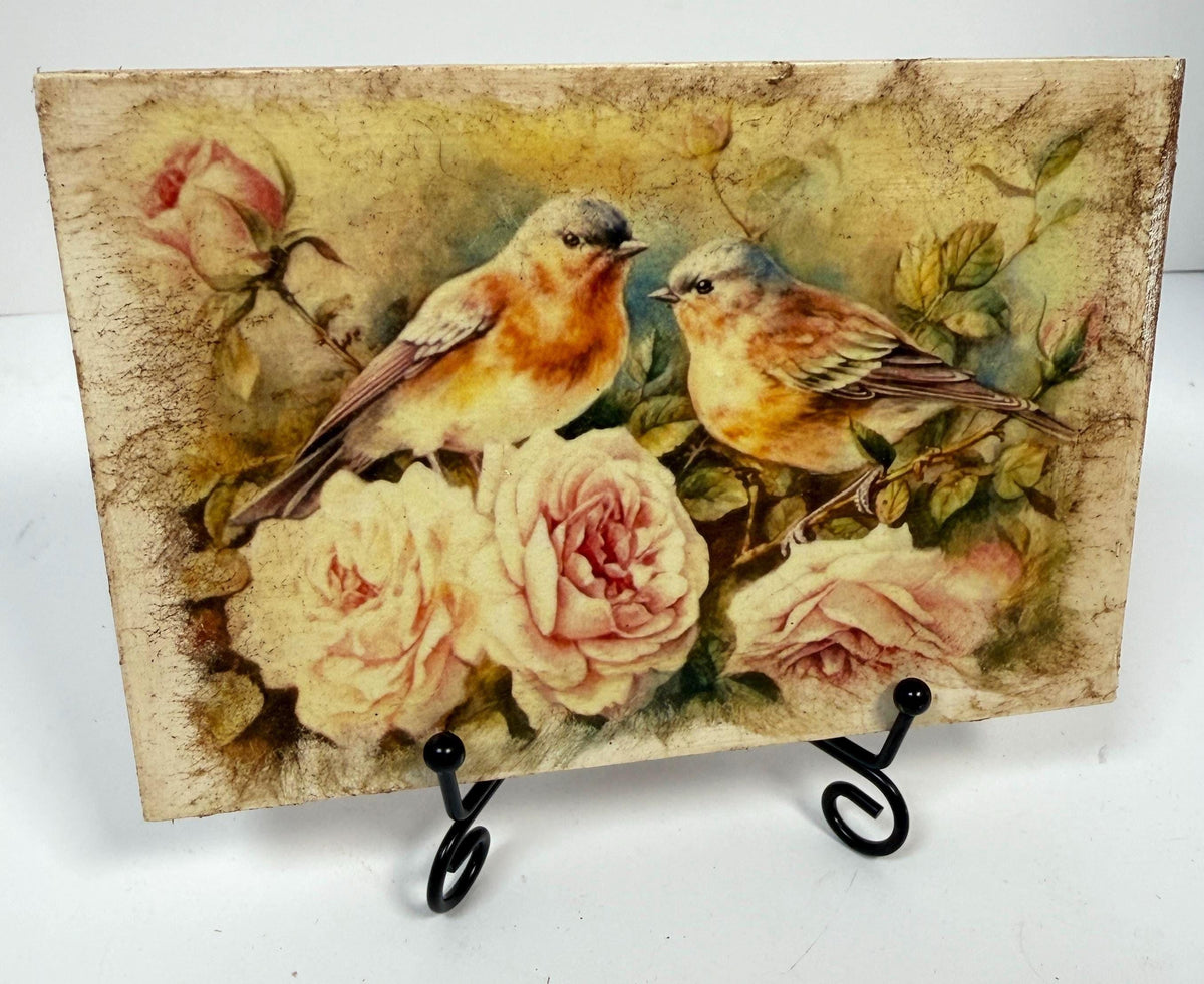 a painting of two birds perched on branches with pink roses in the background.