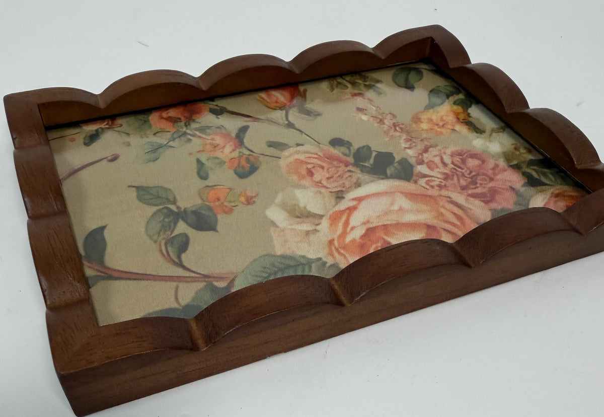 a wooden tray with a floral pattern on it.